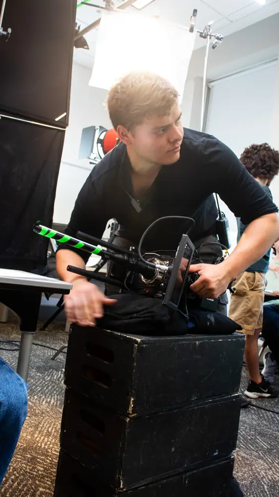 Matthew Nelson prepping a camera rig on set